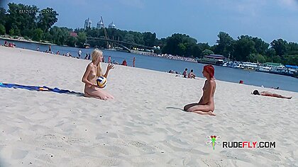 Adorable nudist sunbathes nude...